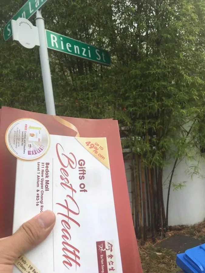 A property promotion photographed beside a residential street sign.