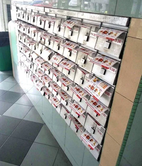 Campaign material placed across a bank of residential letterboxes.
