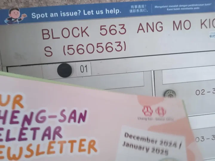 A community newsletter photographed at Ang Mo Kio HDB letterboxes.