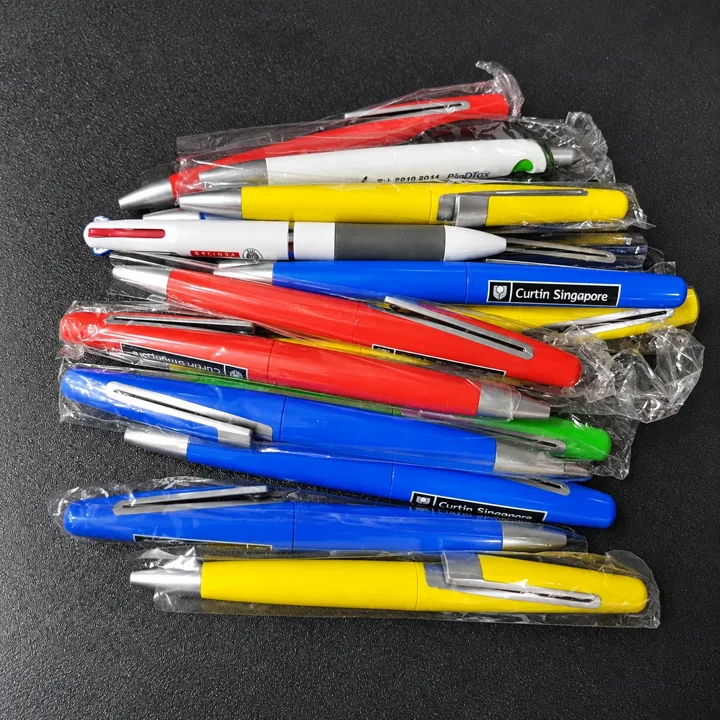 A selection of branded promotional pens, shown together in their individual sleeves.