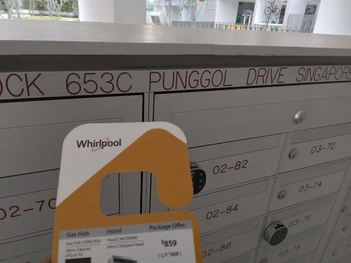 A Whirlpool promotional flyer photographed at Block 653C Punggol Drive letterboxes.