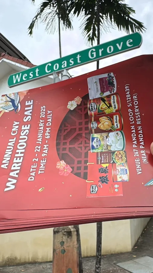 A promotional flyer photographed beside the West Coast Grove street sign.