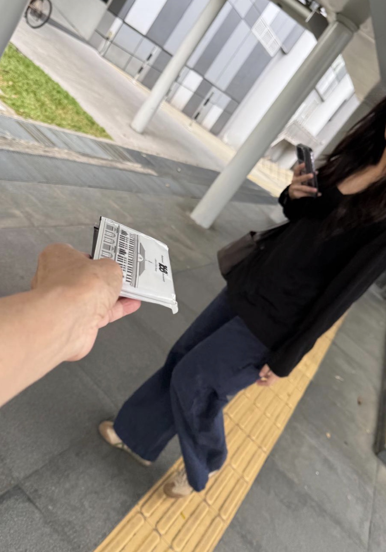 Branded tissue packet handout during a street promotion in Singapore